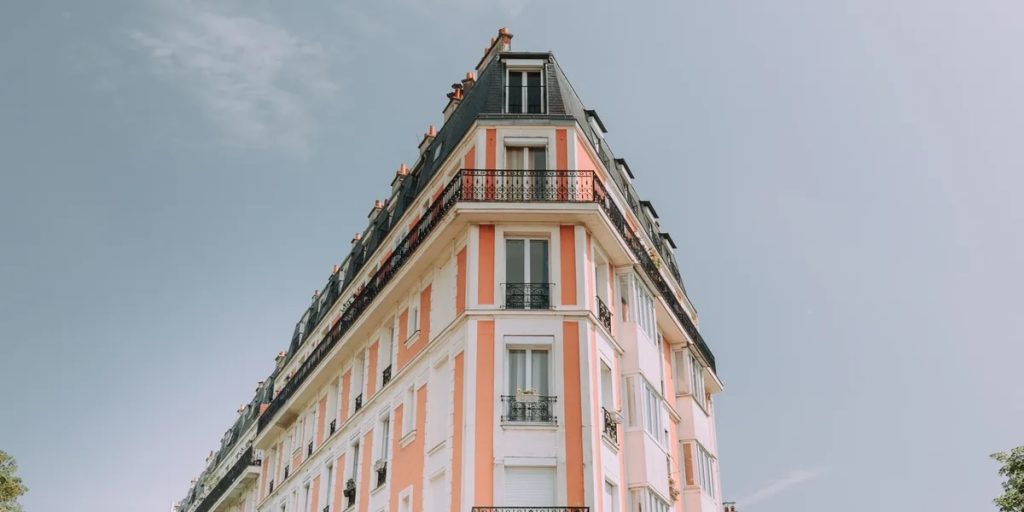 Pink and white wedge-shaped corner building.